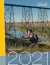 Cover for the 2021 Annual Report for Tourism Lethbridge. The cover geartures a young woman climbing the west side of the old man river coulees.