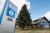 the sign outside the visitor information centre as well as some of the visitor information centre in Lethbridge Alberta. the sign has the tourism LEthbrgdieg logo on it with the large I symbol for information, as well as a neon open sign to indicate open status.